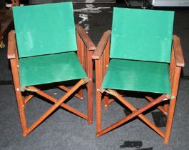 Pair of folding green canvas on wood frame directors style chairs.