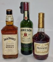 Three bottles of alcohol: Jack Daniel's Tennessee Honey 1L, Jameson Irish Whiskey 700ml and Hennessy