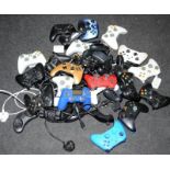 A large quantity of games controllers. Various makes and models