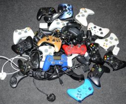 A large quantity of games controllers. Various makes and models