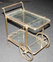 A two tier vintage brass tea/drinks trolley with glass shelves 76x69x43cm.