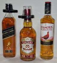 Three bottles of alcohol: Chivas Regal Scotch Whisky, Johnnie Walker Black Label Scotch Whisky and