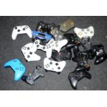 A quantity of games controllers. Various makes and models