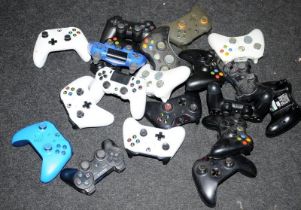 A quantity of games controllers. Various makes and models