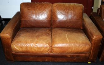 A contemporary tan leather two seater settee 70x150x95cm.