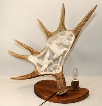 Large antler horn with incised carving depicting wildfowl in flight. Mounted on a wooden base and