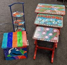 3 items of individually designed furniture a folding cake stand , nest of 3 tables and a small tin