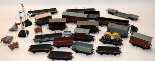 A tray of loose OO gauge rolling stock and station furniture. Mostly of metal construction