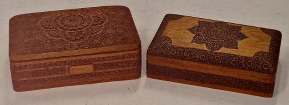 Two heavily carved wooden decorative cigarette boxes.