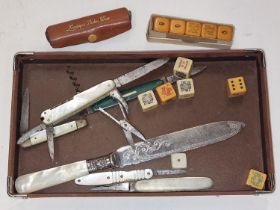 Mixed curios to include mother of pearl penknives and vintage dice.
