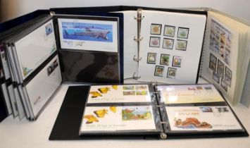 Four albums containing Guernsey FDC's and a good quantity of Jersey mint stamps sheets and