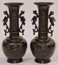 Pair of oriental bronze vases each 32cm tall.