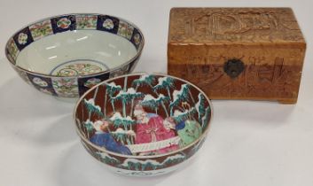 A carved wooden lidded box together with two oriental porcelain bowls please examine (3).