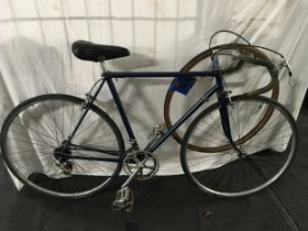 A vintage gents bicycle with spare tyre.