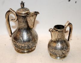 Middle Eastern coffee pot and water jug. Marked 800 to base. Coffee pot 20.5cms tall. 827g