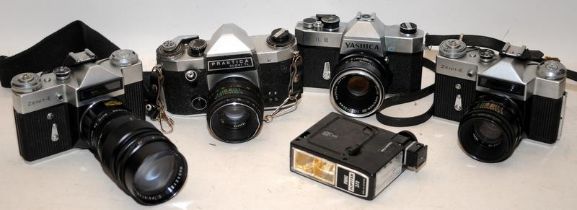 A carton of vintage cameras and lenses to include Yashica, Pentacon and Zenit