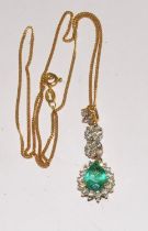 An 18ct gold emerald and diamond pendant on 18ct gold chain. (boxed)