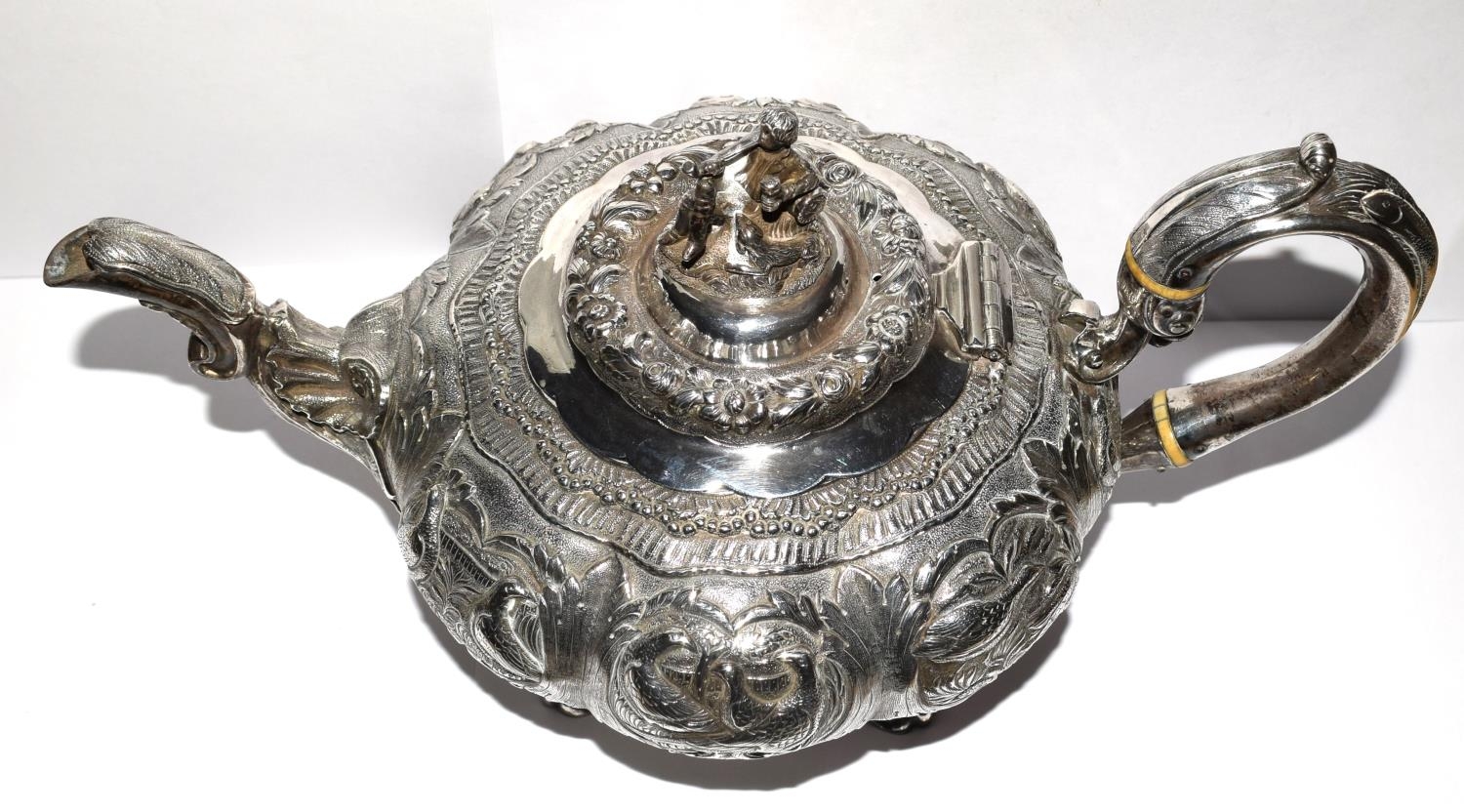 A superb example of a Georgian silver Tea pot heavily embossed with blank cartouche and surmounted - Image 2 of 11