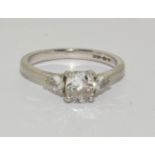 A Diamond solitaire with two side stones approx 0.80points set in a platinum ring, Boxed (Size M)