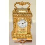 Rococo style Miniature carriage clock and key working at time of cataloguing
