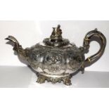 A superb example of a Georgian silver Tea pot heavily embossed with blank cartouche and surmounted