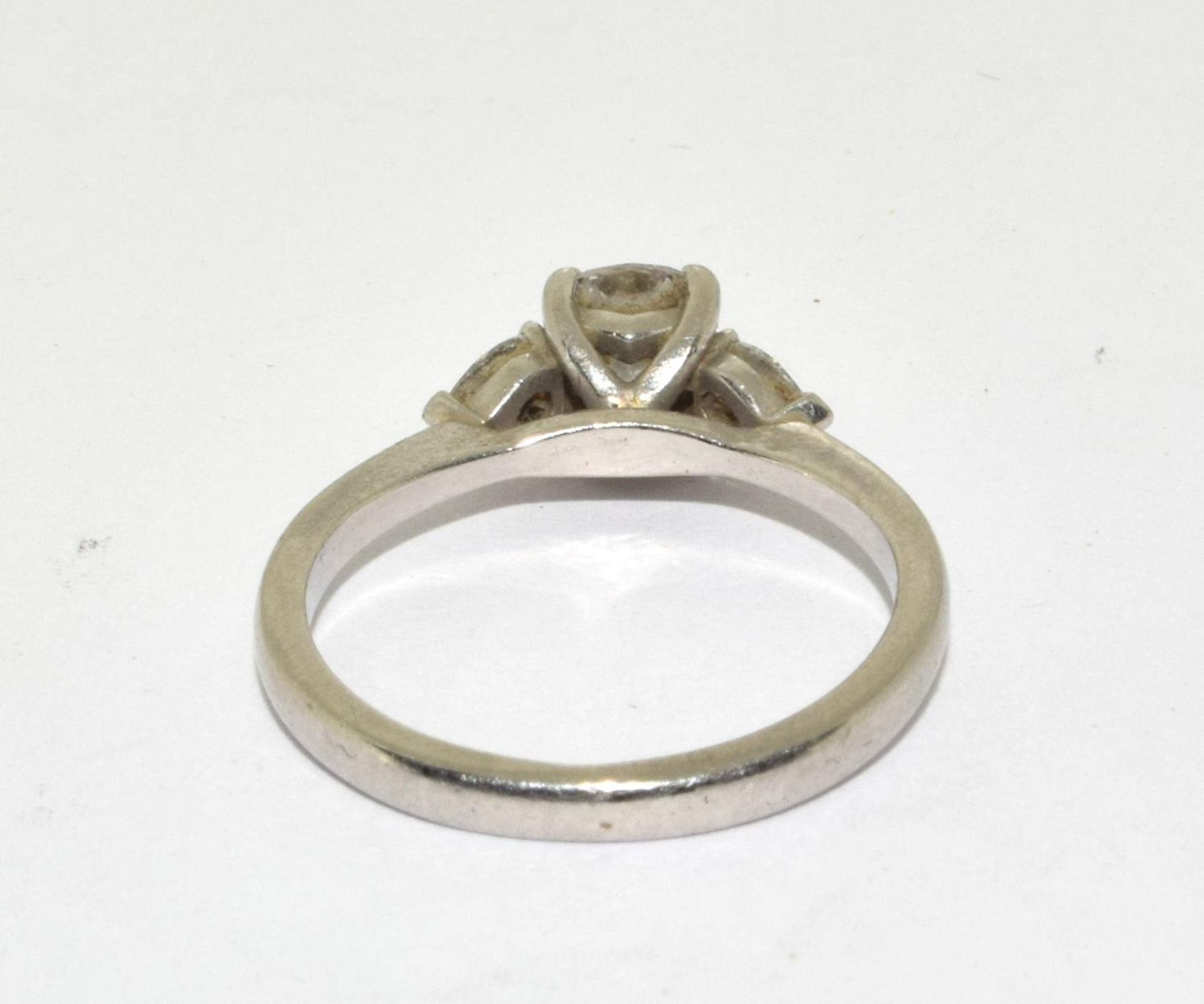 A Diamond solitaire with two side stones approx 0.80points set in a platinum ring, Boxed (Size M) - Image 3 of 5