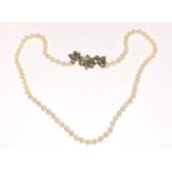 A pearl necklace with 18ct gold clasp, diamonds and sapphires set into the clasp with silver top.