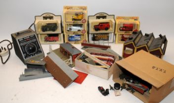 A box of OO gauge trackside buildings c/w a quantity of Lledo Days Gone vehicles