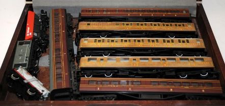 A case containing a quantity of Hornby and Bachmann OO gauge carriages and wagons