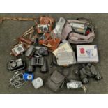 A collection of vintage and modern cameras/camcorders with some accessories.