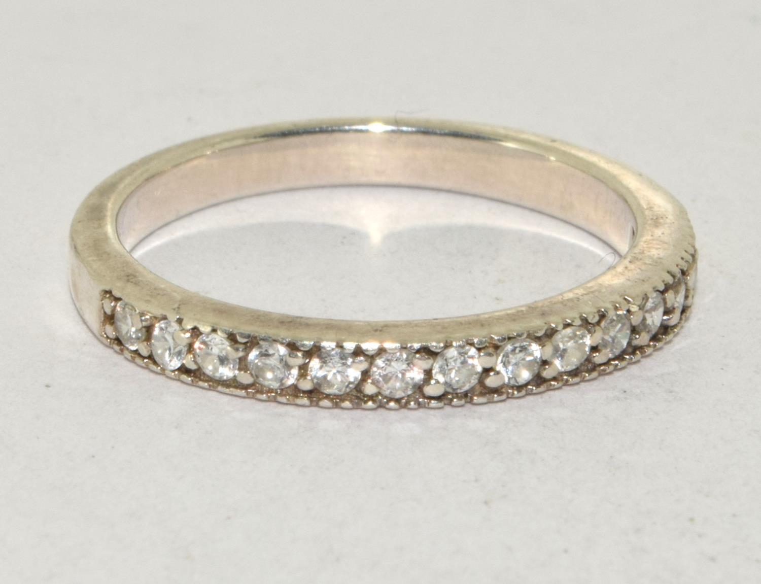 A 925 silver and CZ half eternity band. Size Q