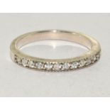 A 925 silver and CZ half eternity band. Size Q