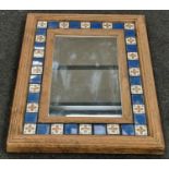 Vintage oak framed wall mirror with decorative blue and white tiled border 86x65cm.