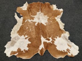 A vintage animal hide rug 128x126cm approx.