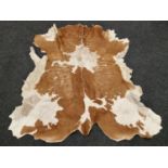 A vintage animal hide rug 128x126cm approx.