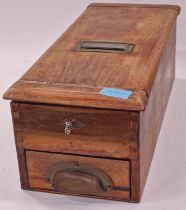 A vintage wooden cash register with key.