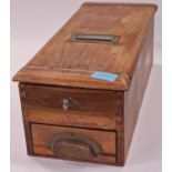 A vintage wooden cash register with key.