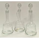 Three etched glass decanters with stoppers.