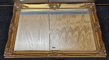 Gilt framed contemporary wall mirror with bevelled edged glass 89x64cm.