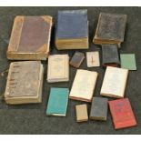 A large collection of vintage bibles and religious books of different sizes and conditions.