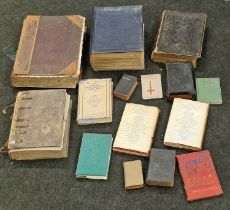 A large collection of vintage bibles and religious books of different sizes and conditions.