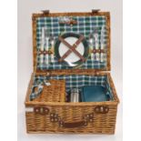A vintage wicker complete picnic set for two looks unused.