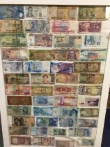 Framed and glazed bank notes.