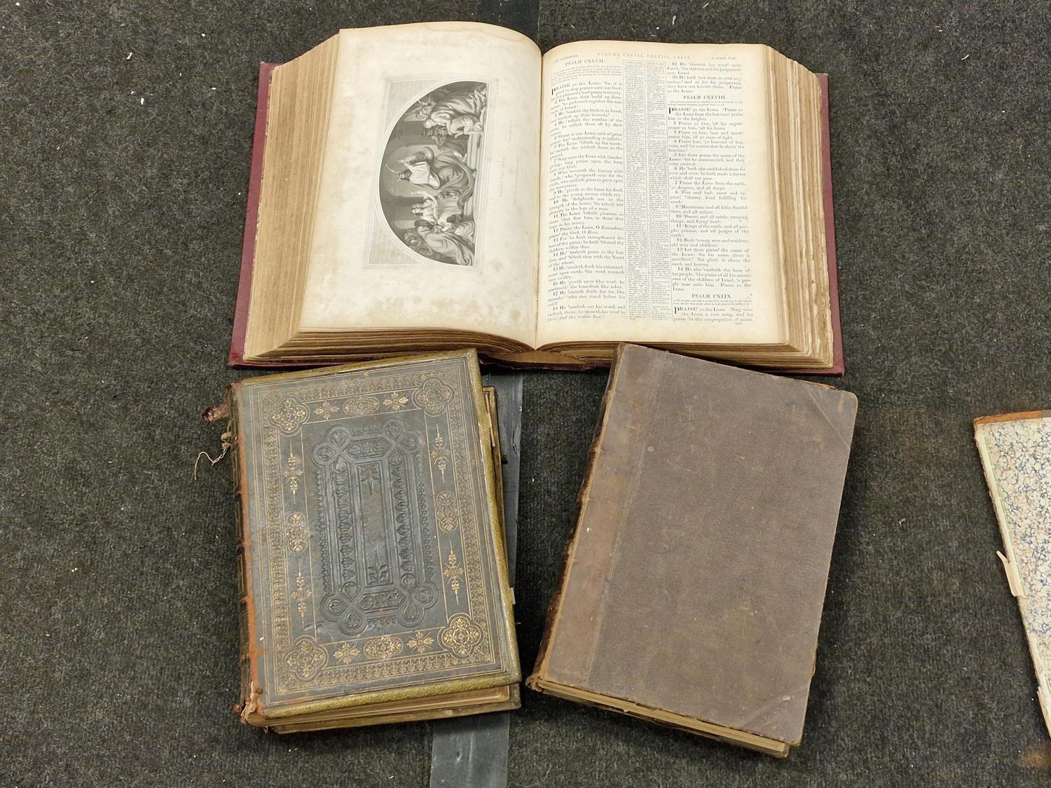 Collection of three antique hardback family bibles.