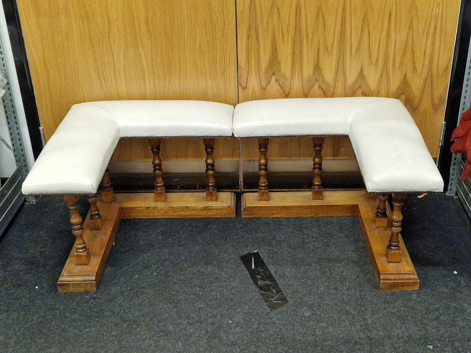 A pair of vintage oak fireside benches with white leather upholstered seats each 50cm x 67cm x 66cm.