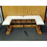 A pair of vintage oak fireside benches with white leather upholstered seats each 50cm x 67cm x 66cm.