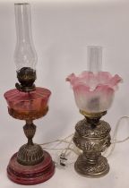 Two vintage oil lamps one being converted to electric.