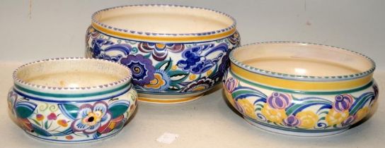 Three early 20thC Poole Pottery bowls in traditional patterns. Largest bowl (with a number of