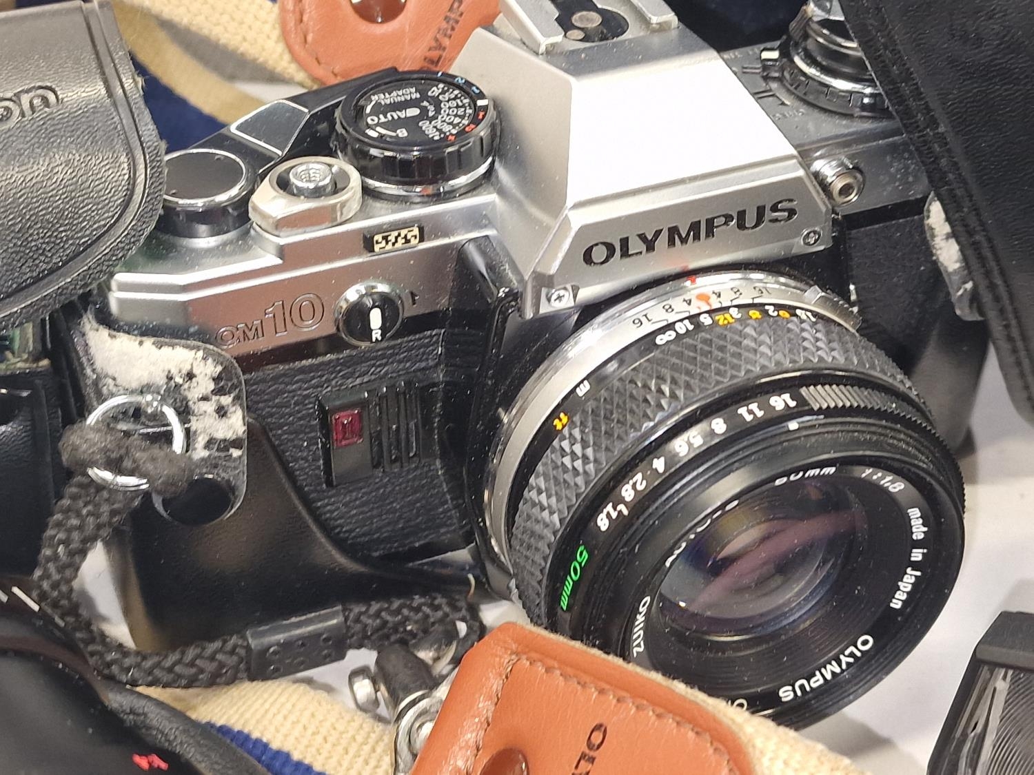 Olympus OM10 camera together with some lenses and accessories in an Olympus carry bag. - Image 2 of 3