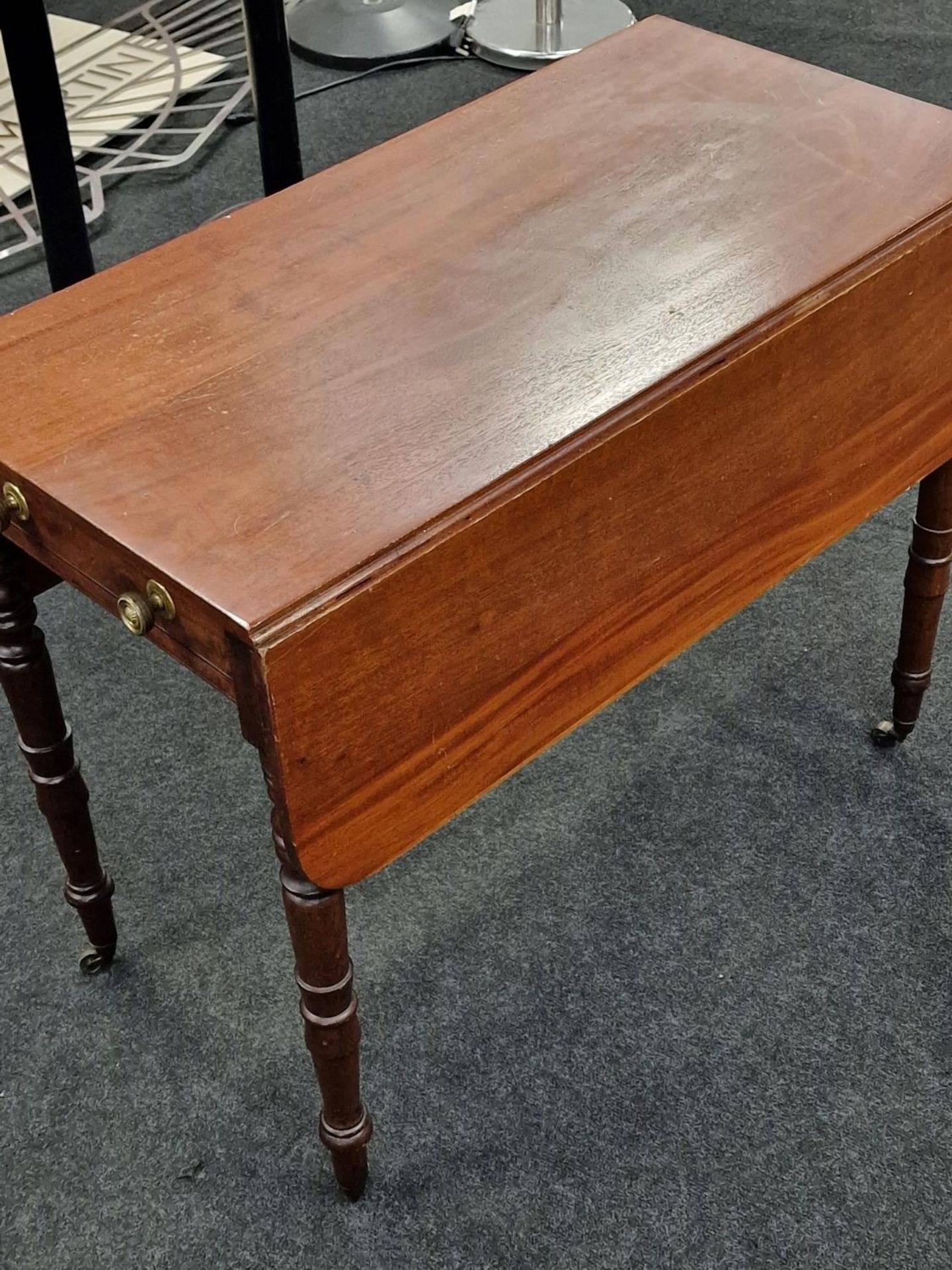Mahogany Pembroke table supported by turned supports above brass castors having a single draw to one - Image 2 of 2